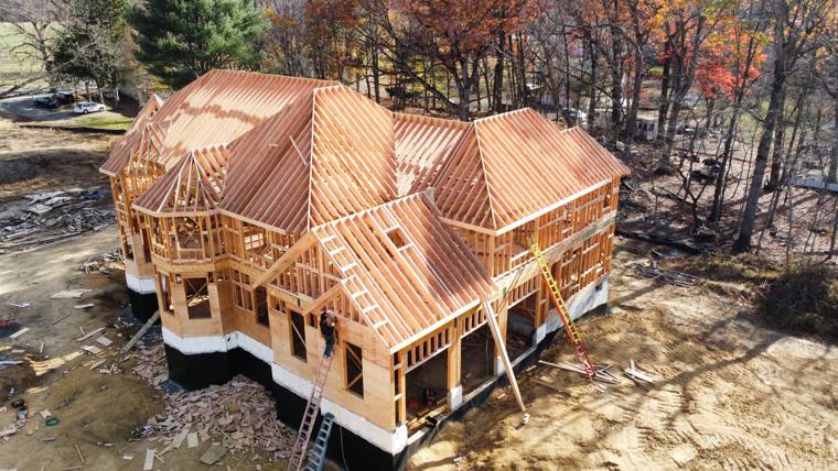 Aerial view of a large custom home roof framing