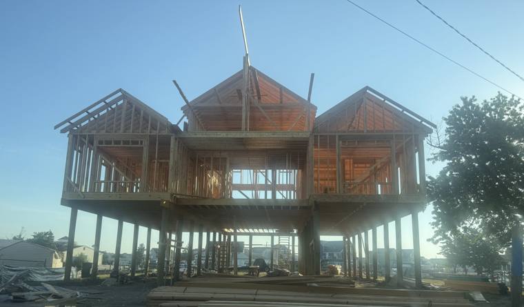 Elevated shore home framing on pilings