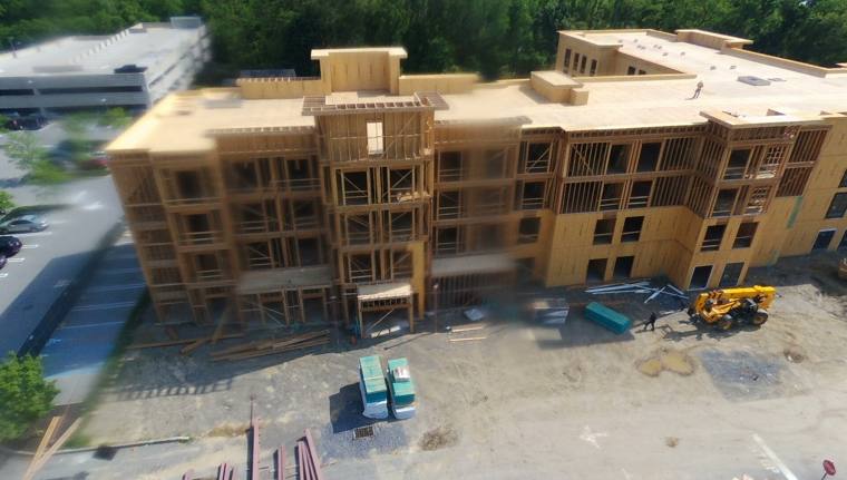 Aerial view of a four-story wood-frame building