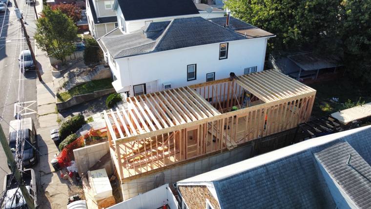 Aerial view of a rear addition being framed