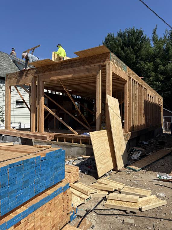 Crew framing a rear home addition