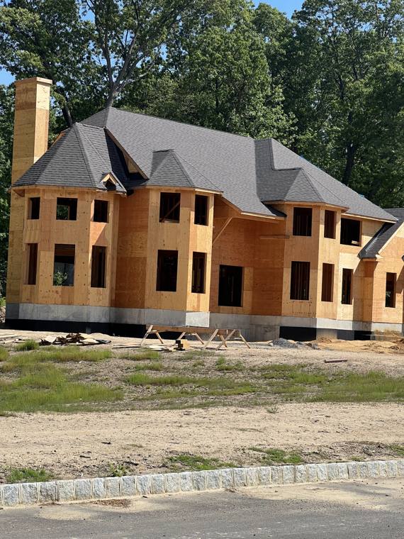 Fully sheathed custom home ready for roofing